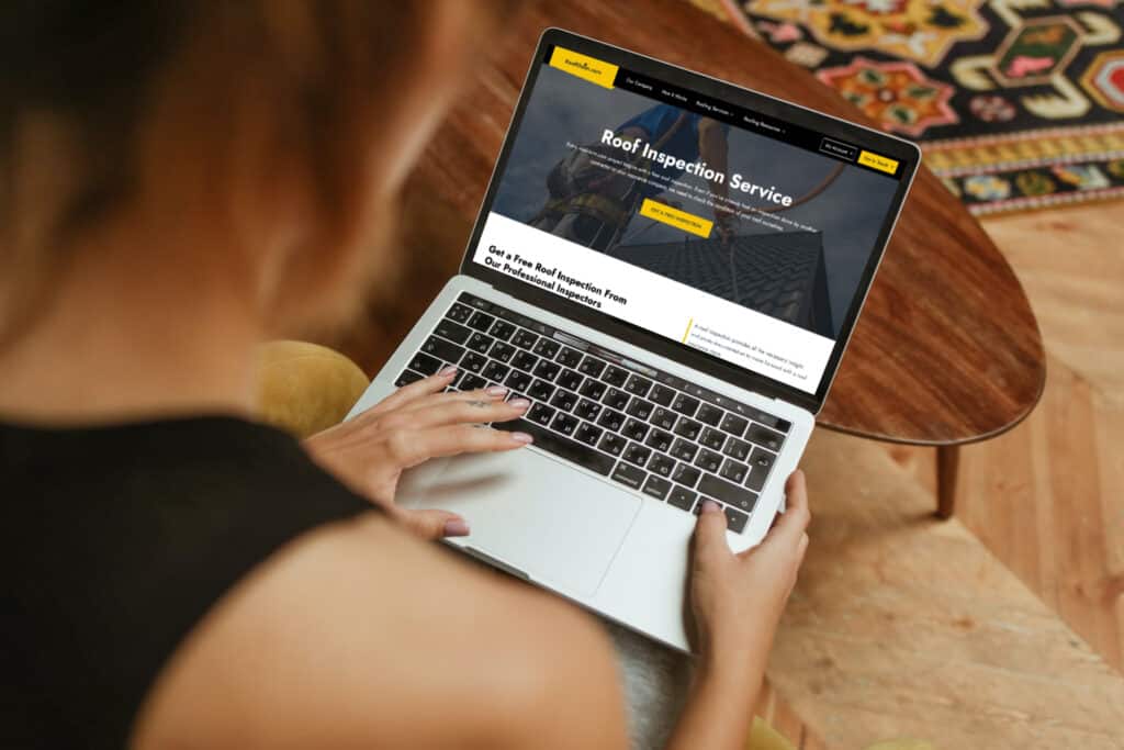 woman looking up roofclaim.com on a laptop to schedule a free roof inspection