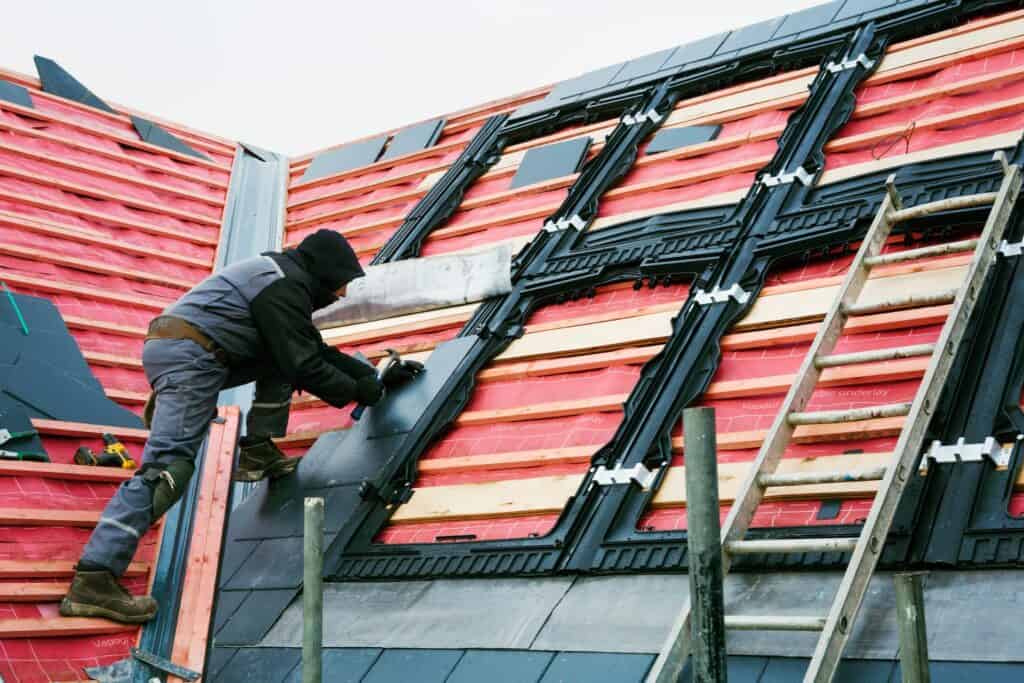 roofing contractor working on a tile roof replacement