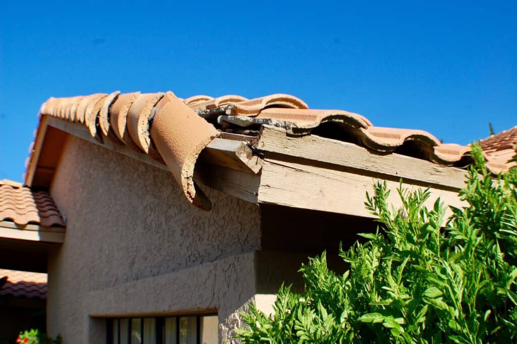 broken tile roof that needs repair to prevent or fix roof leak during heavy rains