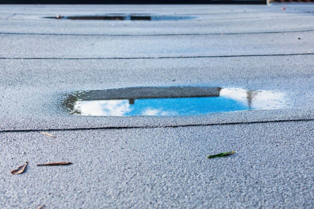 flat roof caving in with puddle from water