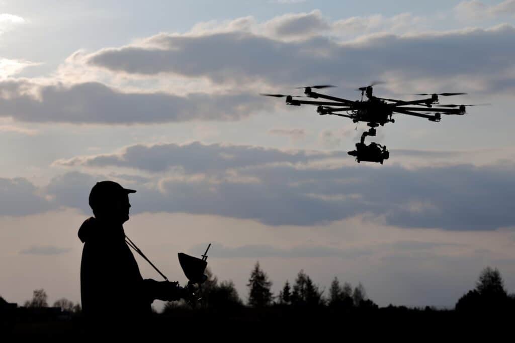 drone pilot flying an advanced drone for a roof inspection