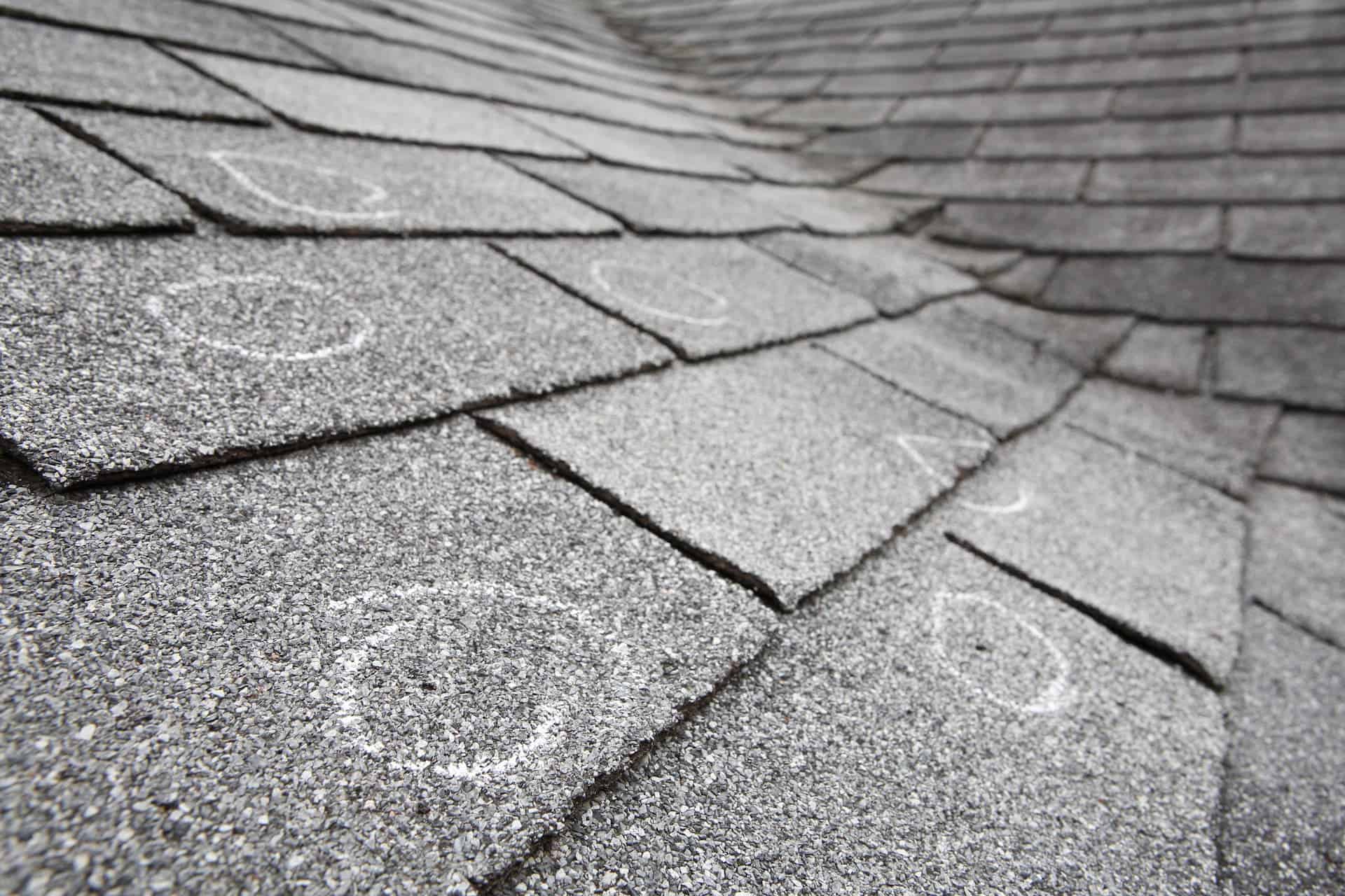 Multiple hail strikes on roof with damage circled