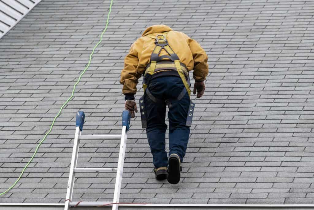 a certified inspector performing a wind mitigation inspection on a shingle roof