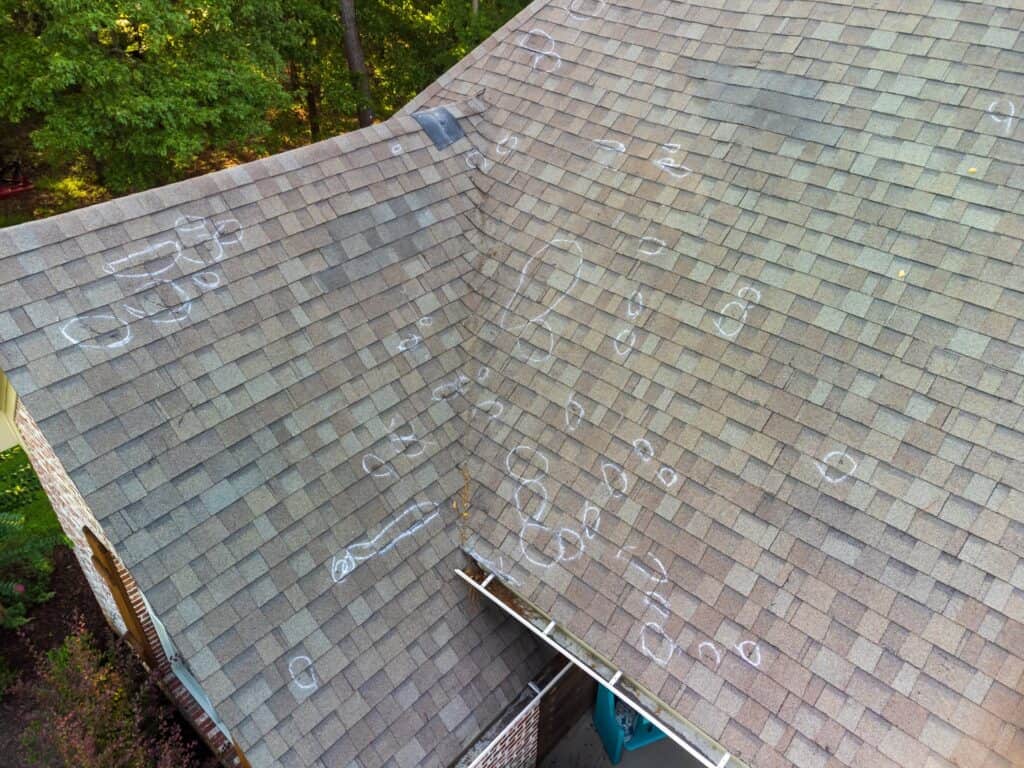 roof with chalk circles around hail damage