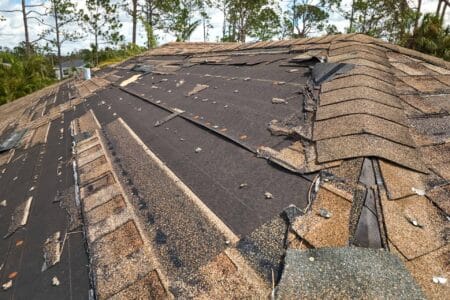 Hurricane Ian destroyed a house roof in Florida residential area. Natural disaster and its consequences.